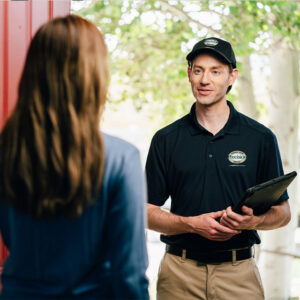A Precision Garage Door Service of NC technician consulting with a customer at their home in Morrisville, NC.