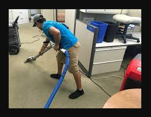 A technician extracting water from carpet in an office at Fresno Water Damage Pros in Fresno, CA.