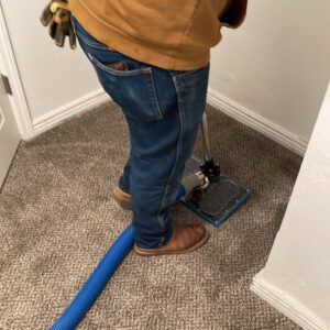 A technician from Idaho Disaster Pros extracting water from a carpet during water damage restoration in Idaho Falls, ID.
