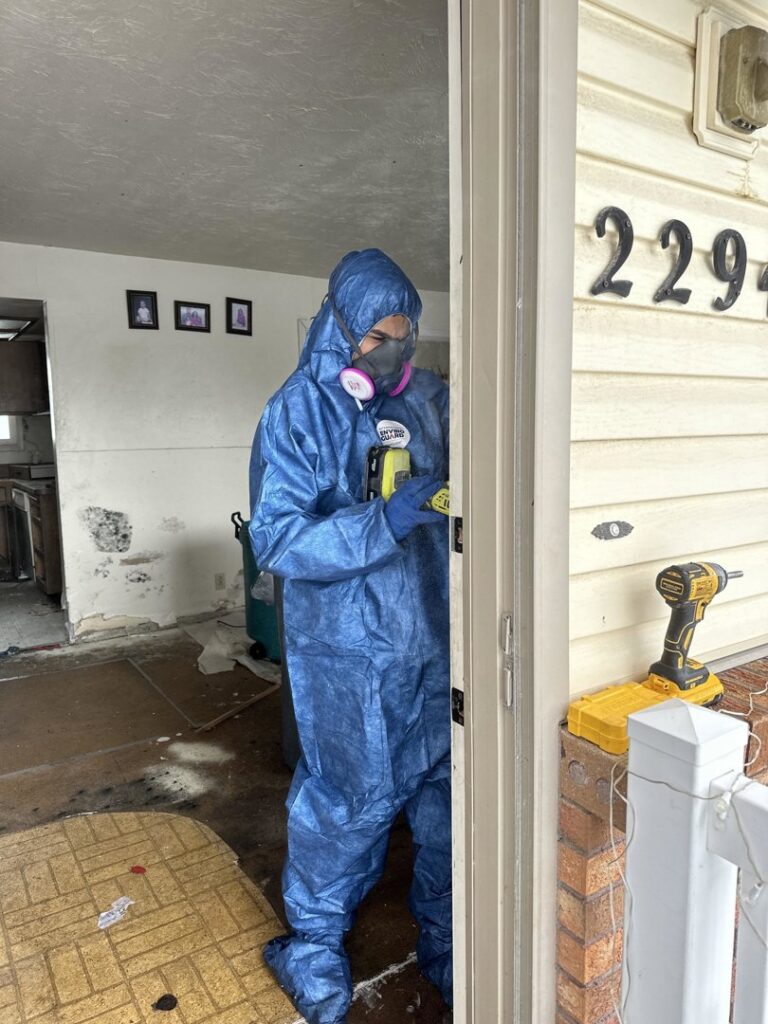 A technician in a hazmat suit and respirator preparing for water damage cleanup and remediation by Idaho Disaster Pros in Idaho Falls, ID.