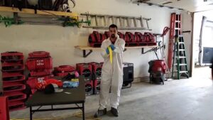 A technician in a hazmat suit with water damage drying equipment, working for PuroClean of Strafford County in Nottingham, NH.