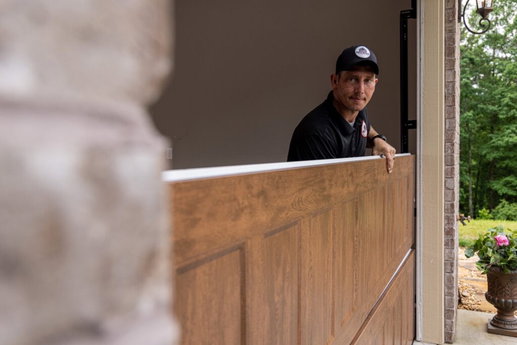 A technician from Access Garage Doors of Treasure Valley installing a new garage door panel in Meridian, ID.