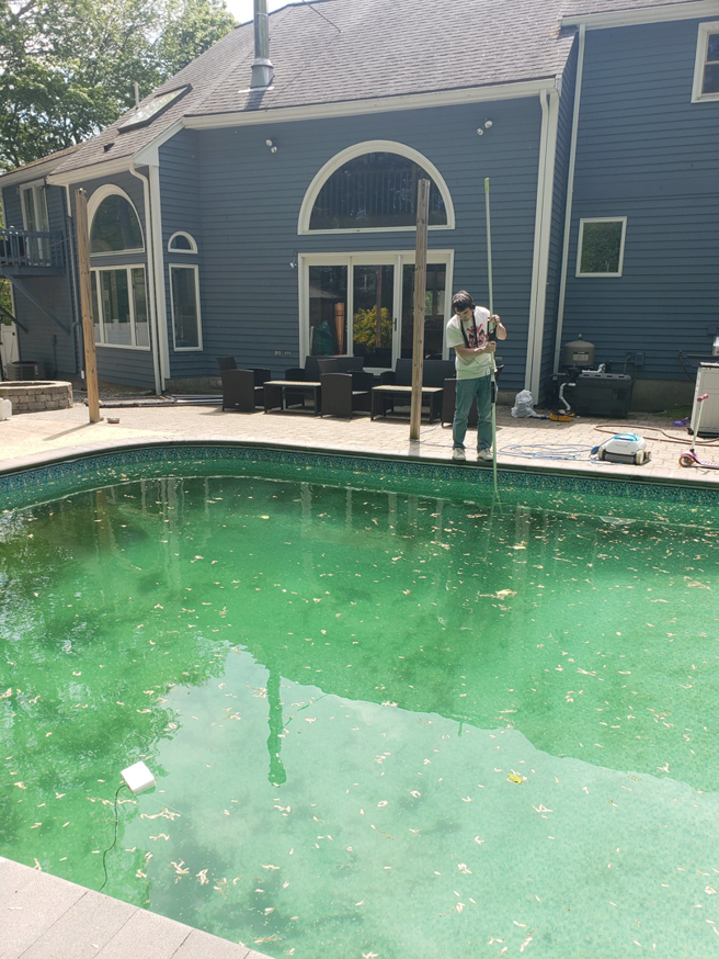 A technician performing a thorough pool inspection for leaks or water damage at South Shore Leak Solutions in Quincy, MA
