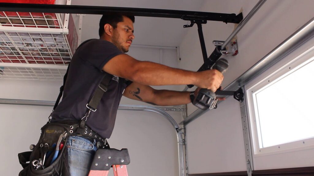 A technician repairing a garage door opener mechanism for Valley Overhead Door in Las Vegas, NV.