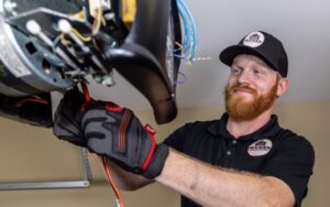 A technician from Access Garage Doors of Treasure Valley servicing a garage door opener in Meridian, ID.