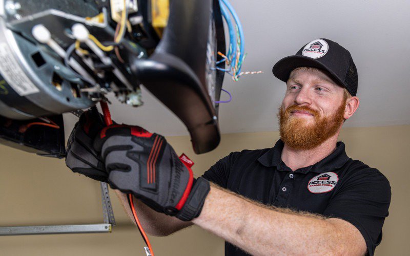 A technician from Access Garage Doors of Treasure Valley servicing a garage door opener in Meridian, ID.