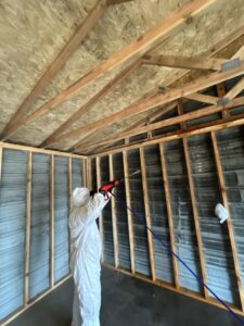 A technician in a hazmat suit spraying for mold remediation after water damage by 406 Disaster Response in Billings, MT.