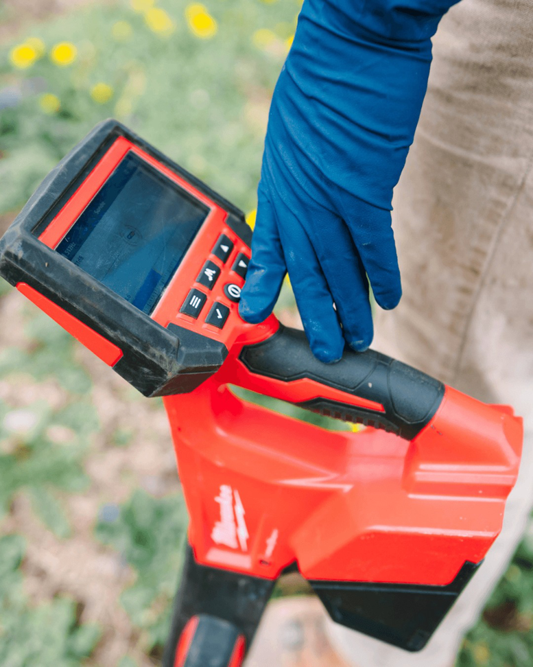 A technician using a leak detection device for water damage assessment at Bright Side Plumbing in Overland Park, KS.