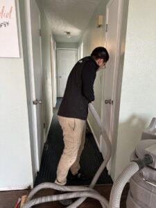 A Restorex technician performing water extraction from a carpeted hallway in Petaluma, CA.