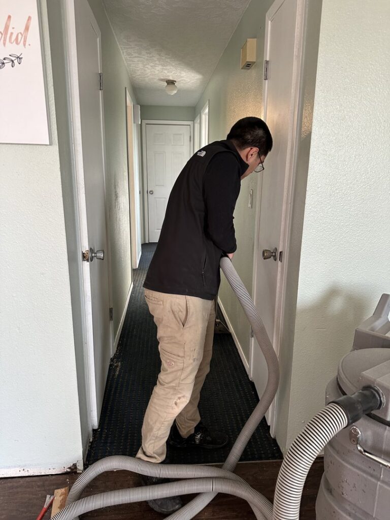 A Restorex technician performing water extraction from a carpeted hallway in Petaluma, CA.