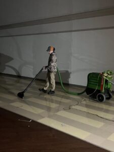 A SERVPRO of South Shreveport technician operating water extraction equipment on a floor in Shreveport, LA.