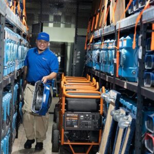 A technician with water damage drying equipment and a generator in a warehouse at AdvantaClean of Cabarrus and Rowan Counties in Concord, NC.