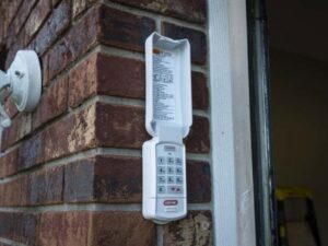 A technician working on a garage door opener, performing service for Up & Down Garage Doors New Haven in New Haven, CT