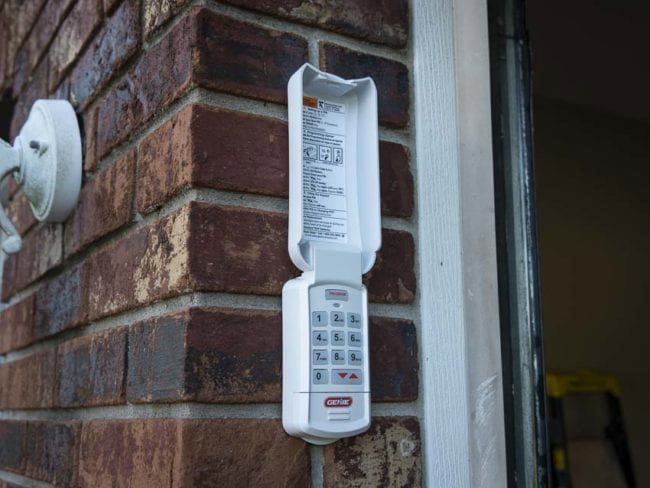 A technician working on a garage door opener, performing service for Up & Down Garage Doors New Haven in New Haven, CT