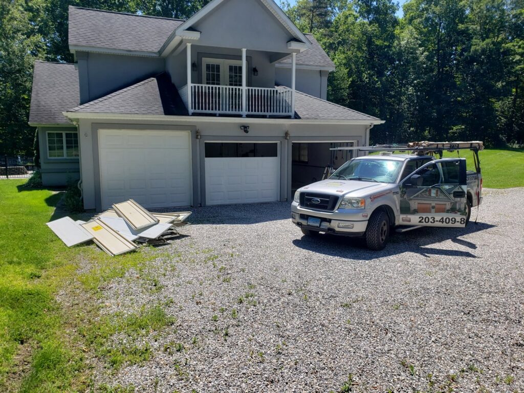 Two technicians installing a commercial garage door for Up & Down Garage Doors New Haven in New Haven, CT