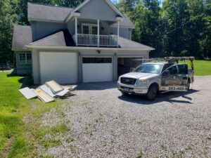 Two technicians installing a commercial garage door for Up & Down Garage Doors New Haven in New Haven, CT