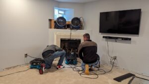 Technicians setting up drying equipment for water damage restoration in a home by Guardian Angel Restoration in Noblesville, IN