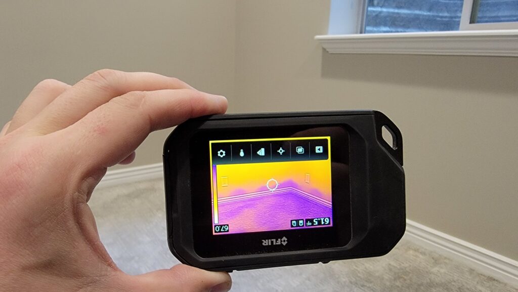 A technician uses a thermal camera for moisture detection during a water damage assessment by Utah Disaster Team in Layton, UT.