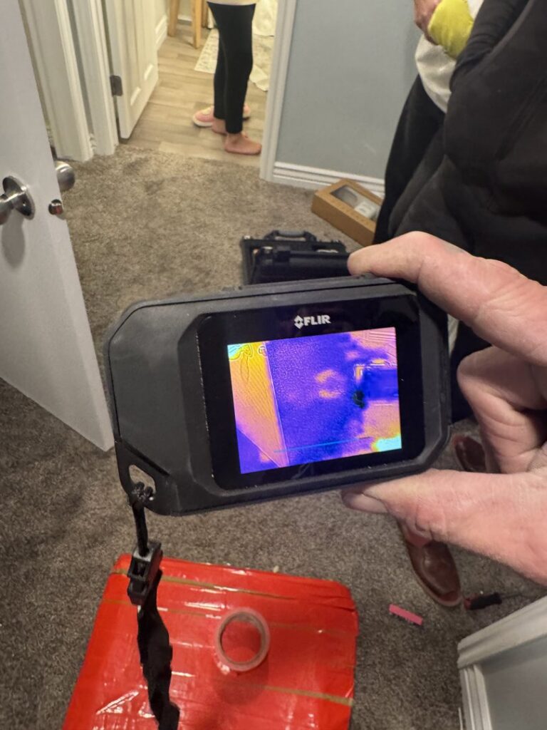 A thermal camera being used to scan for hidden moisture during a water damage assessment by Utah Flood Guys in Sandy, UT.