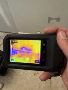 A thermal imaging camera being used to detect hidden moisture, a service provided by Minutemen Property Damage Services in North Charleston, SC.