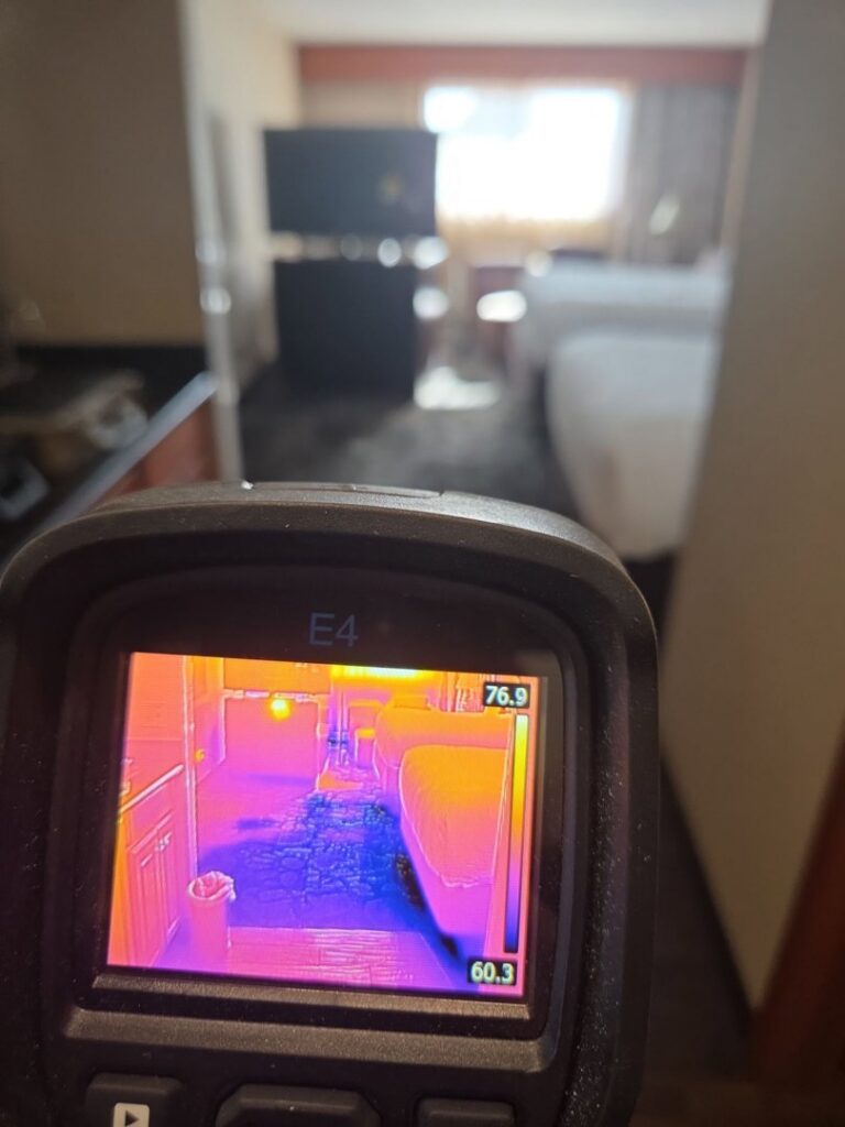 A thermal imaging camera detecting hidden moisture, used for water damage assessment by North Shore Restore in Duluth, MN
