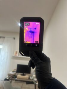A thermal imaging camera being used to detect hidden water damage by RestoPros Hudson County in Jersey City, NJ.