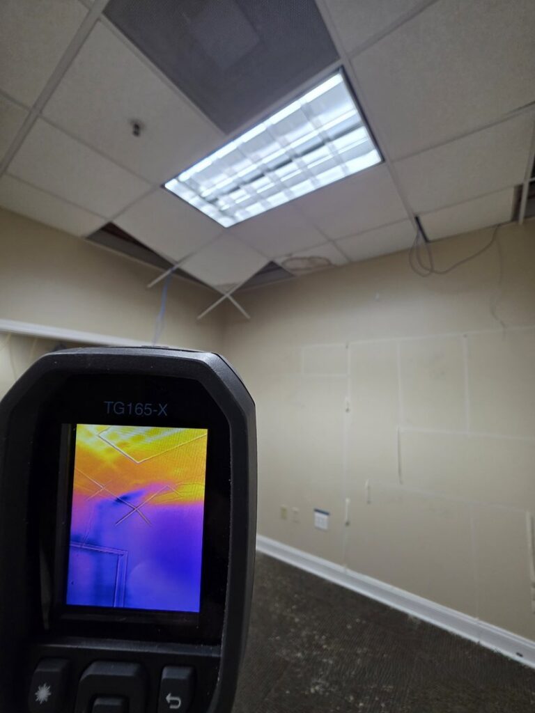 A thermal imaging camera detecting water damage in a ceiling with visible damage, performed by Remont Restoration in Hagerstown, MD.