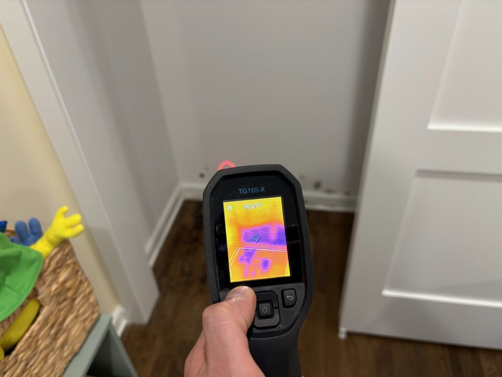 A thermal imaging camera detecting moisture in a wall during water damage inspection by Mold Master Restoration in Jersey City, NJ