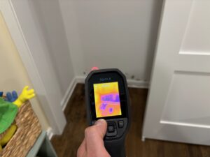 A thermal imaging camera detecting moisture in a wall during water damage inspection by Mold Master Restoration in Jersey City, NJ