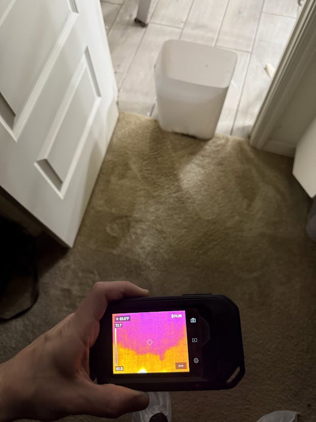 A thermal scan detecting hidden moisture in a carpeted area during a water damage inspection by Flow State Restoration in Gilbert, AZ