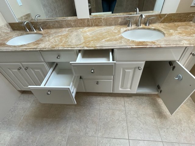 A thoroughly cleaned bathroom vanity with open drawers, showing attention to detail by Straight Up Cleaning in South Portland, ME.