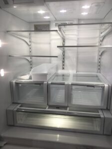 A thoroughly cleaned and empty refrigerator interior, highlighting the deep cleaning services offered by A Clean Xscape LLC in Chandler, AZ.