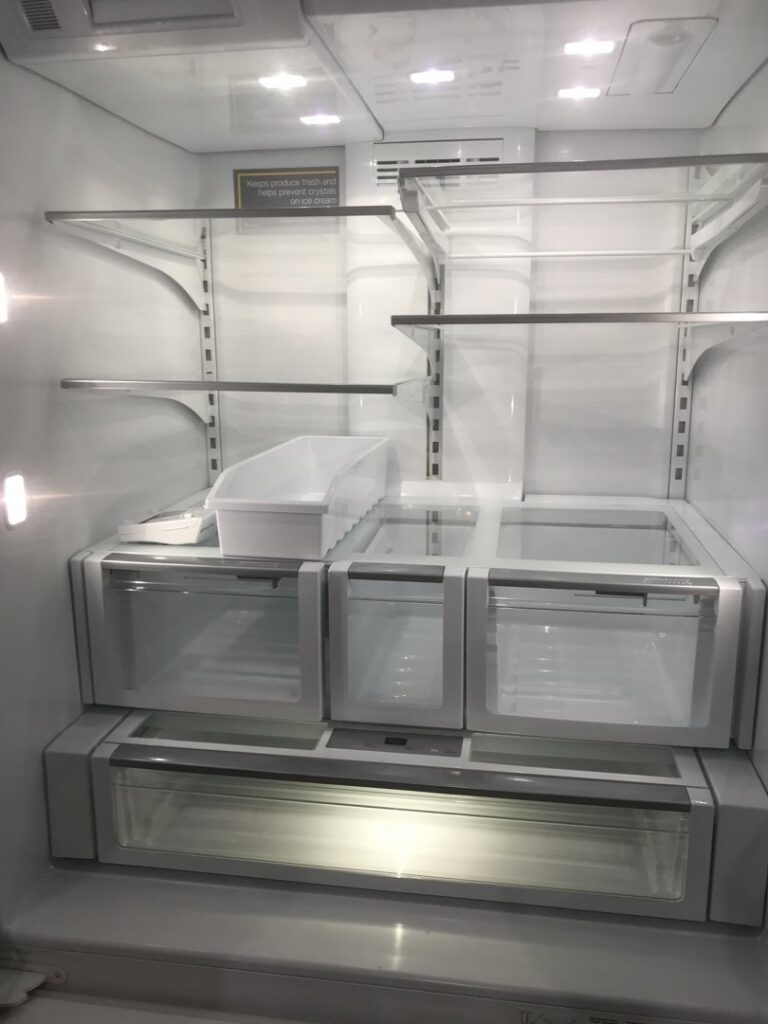 A thoroughly cleaned and empty refrigerator interior, highlighting the deep cleaning services offered by A Clean Xscape LLC in Chandler, AZ.