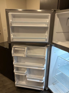 A thoroughly cleaned refrigerator interior, demonstrating the detailed work of Jess Cleaning in San Antonio, TX.