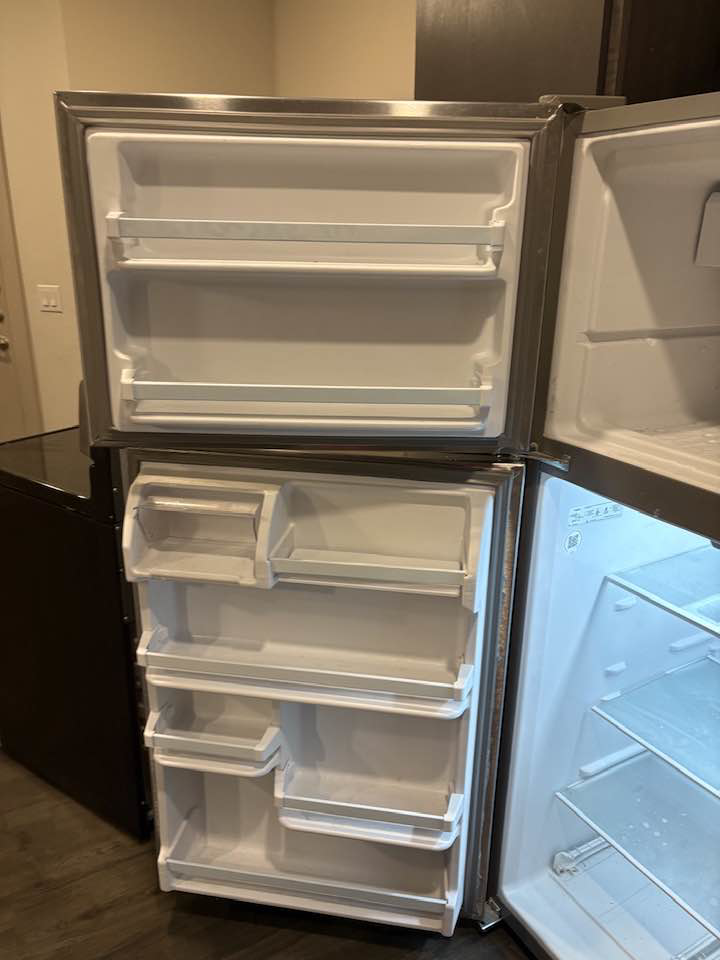 A thoroughly cleaned refrigerator interior, demonstrating the detailed work of Jess Cleaning in San Antonio, TX.