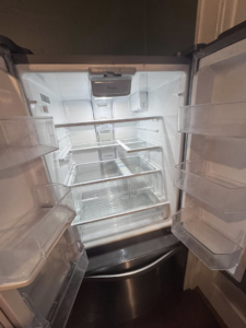 The interior of a spotless and thoroughly cleaned refrigerator, a service offered by Pristine Cleaning Services in Thornton, CO.