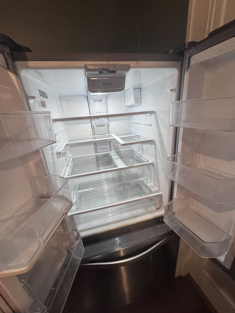 The interior of a spotless and thoroughly cleaned refrigerator, a service offered by Pristine Cleaning Services in Thornton, CO.