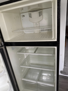 A thoroughly cleaned and empty refrigerator interior, showcasing deep cleaning by Sophia's Cleaning service LLC in Manassas, VA.