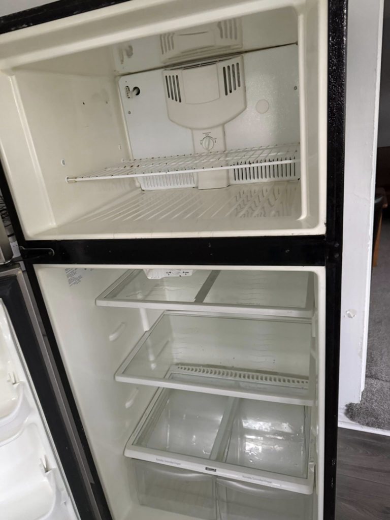 A thoroughly cleaned and empty refrigerator interior, showcasing deep cleaning by Sophia's Cleaning service LLC in Manassas, VA.