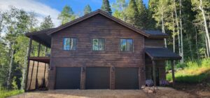 Three modern black residential garage doors installed on a house, a project by Right Choice Doors in Layton, UT.