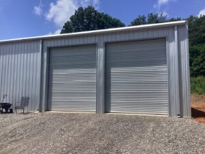 Three black roll-up style commercial garage doors installed by Fayetteville Garage Door Co. in Fayetteville, AR