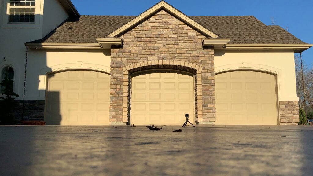 Three new beige panel garage doors installed on a residential home by Garage Door Store Boise, ID.