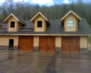 Three wooden carriage-style garage doors installed by Advantage Door Company in Troy, MO.