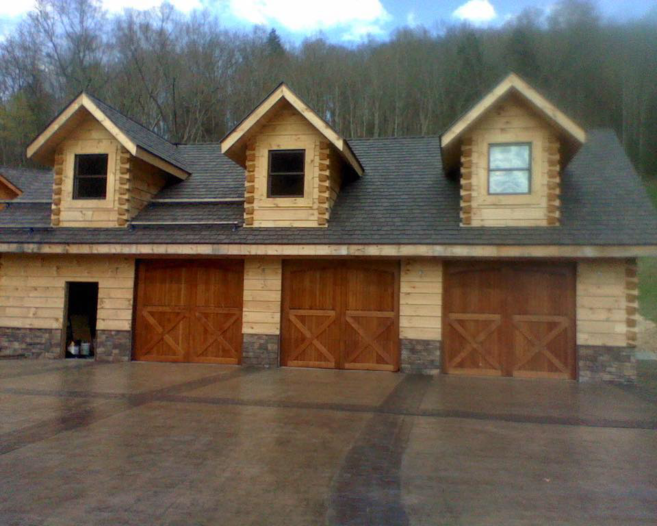 Three wooden carriage-style garage doors installed by Advantage Door Company in Troy, MO.