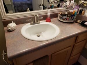 A tidy bathroom vanity with a clean sink and organized toiletries, demonstrating A Clean Xscape LLC's house cleaning in Chandler, AZ.