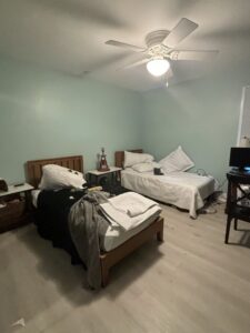 A tidy and well-arranged bedroom with two beds, reflecting the quality house cleaning provided by Cleaning Sisters LLC in Richmond, VA.