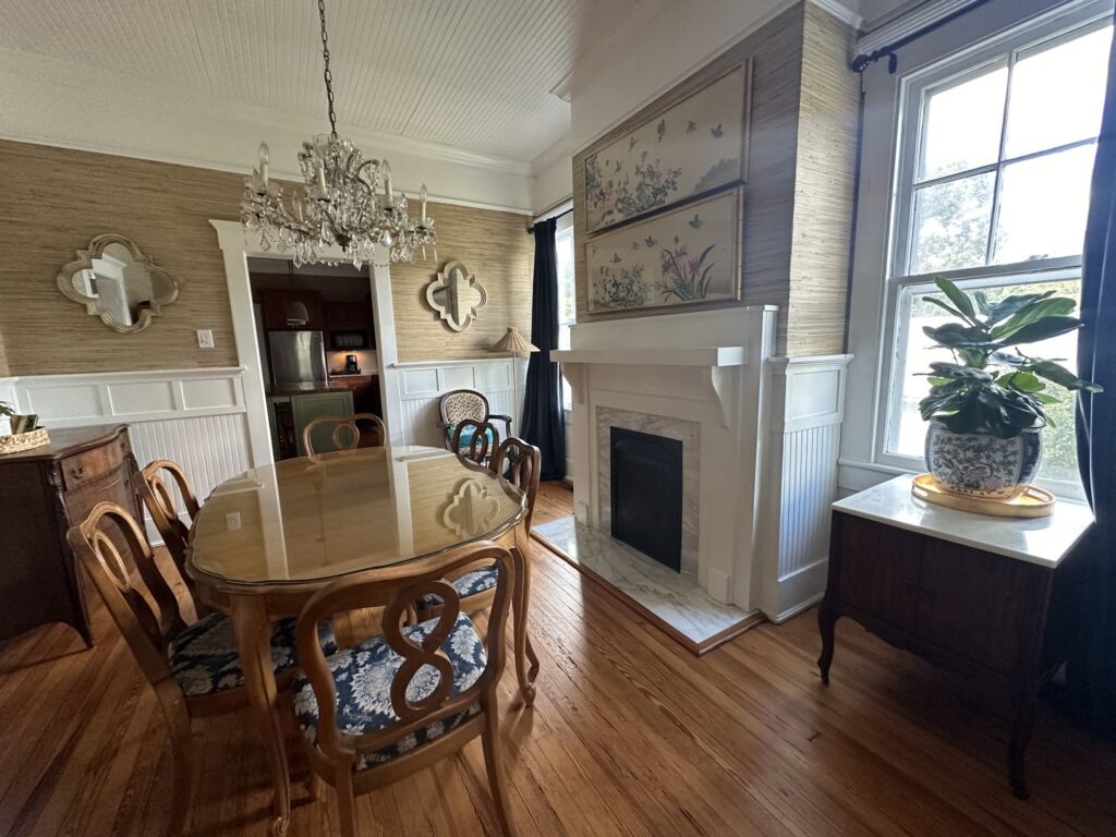 A beautifully tidy dining room featuring a chandelier and wooden furniture, cleaned by Top-Notch Tidy Services in Chesapeake, VA.