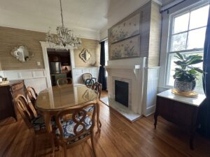 A beautifully tidy dining room featuring a chandelier and wooden furniture, cleaned by Top-Notch Tidy Services in Chesapeake, VA.