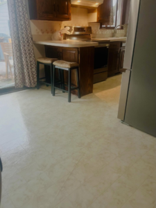 A clean and tidy kitchen area with a spotless floor and counter space, maintained by BLACK PEARL Cleaning CO. in Greenwood, MO.