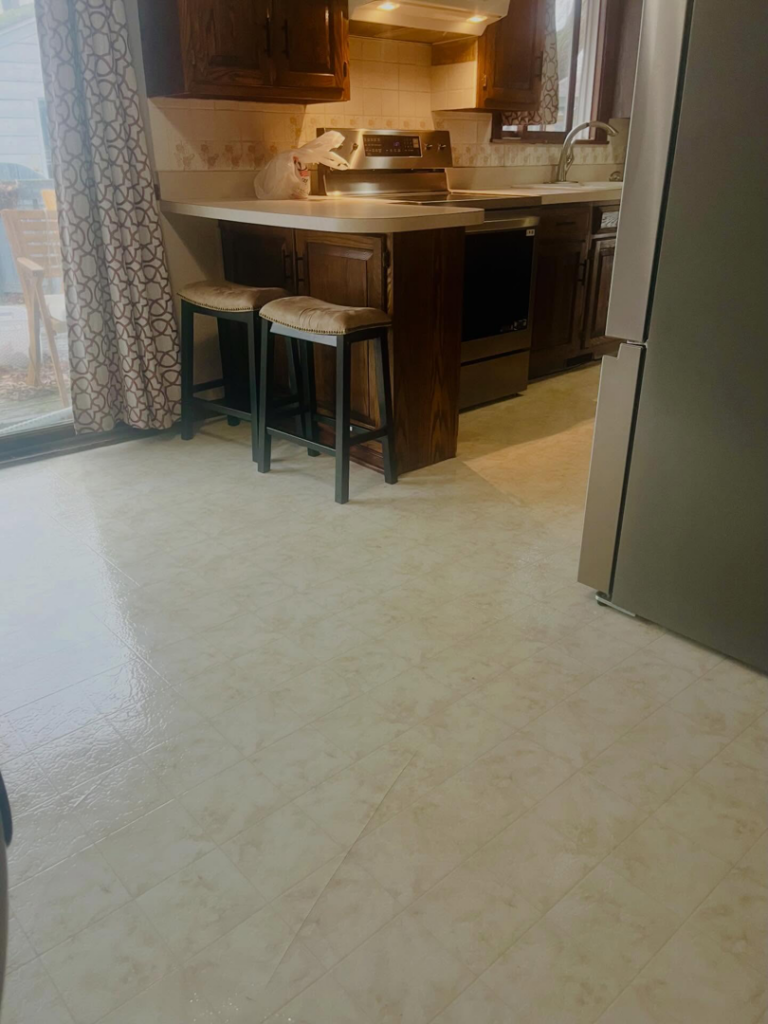 A clean and tidy kitchen area with a spotless floor and counter space, maintained by BLACK PEARL Cleaning CO. in Greenwood, MO.